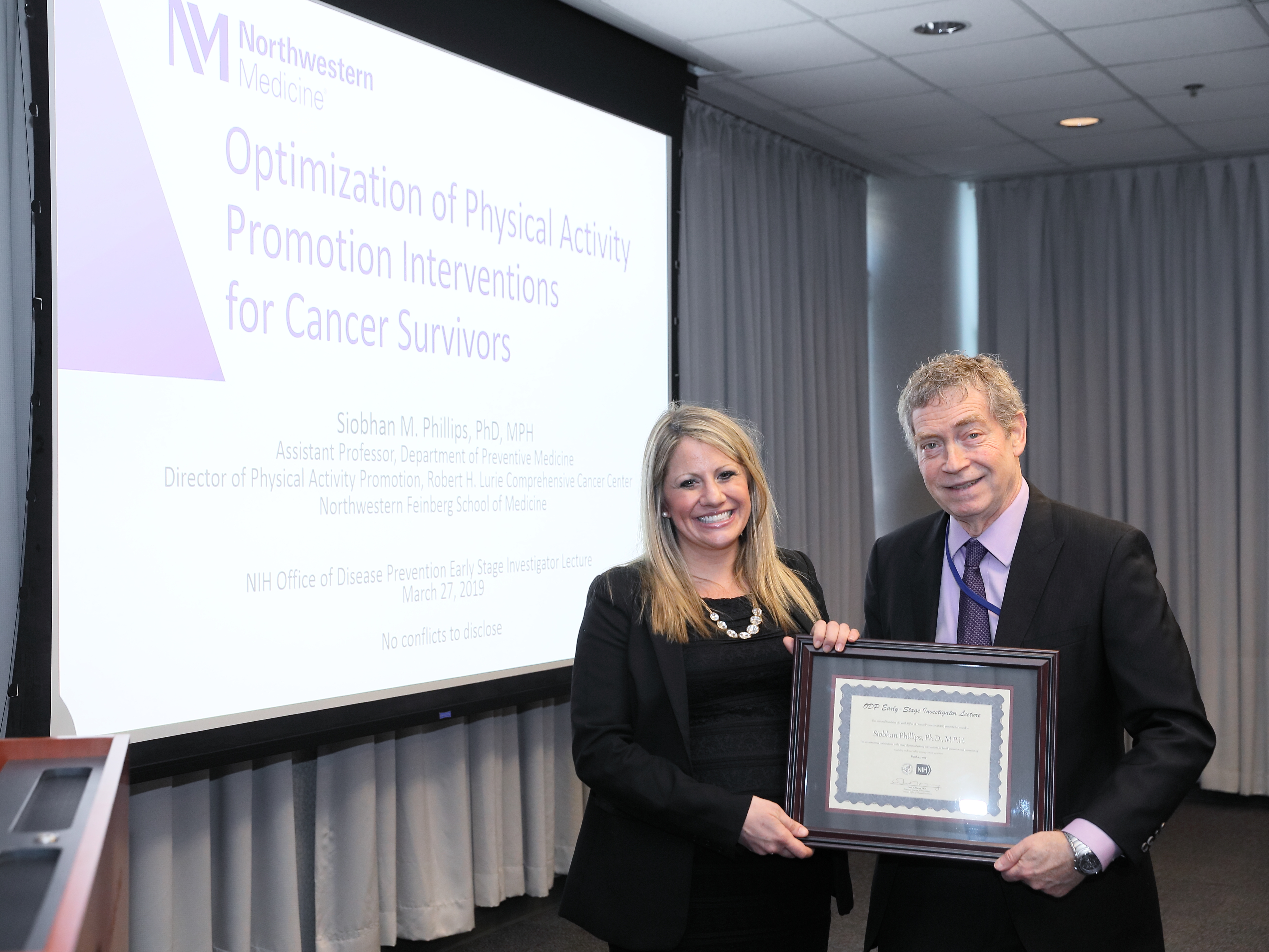 Dr. Phillips receives a certificate from ODP Director Dr. Murray