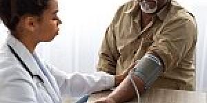 Hypertension In Older Age. Young Female Medical Worker Measuring Arterial Blood Pressure Of Senior Black Man Using Cuff, Patient Having Problems With Tension